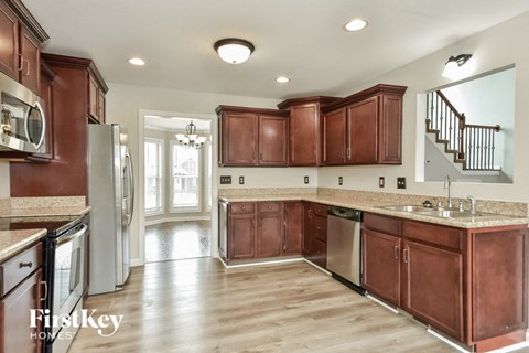 a kitchen with wooden cabinets and stainless steel appliances