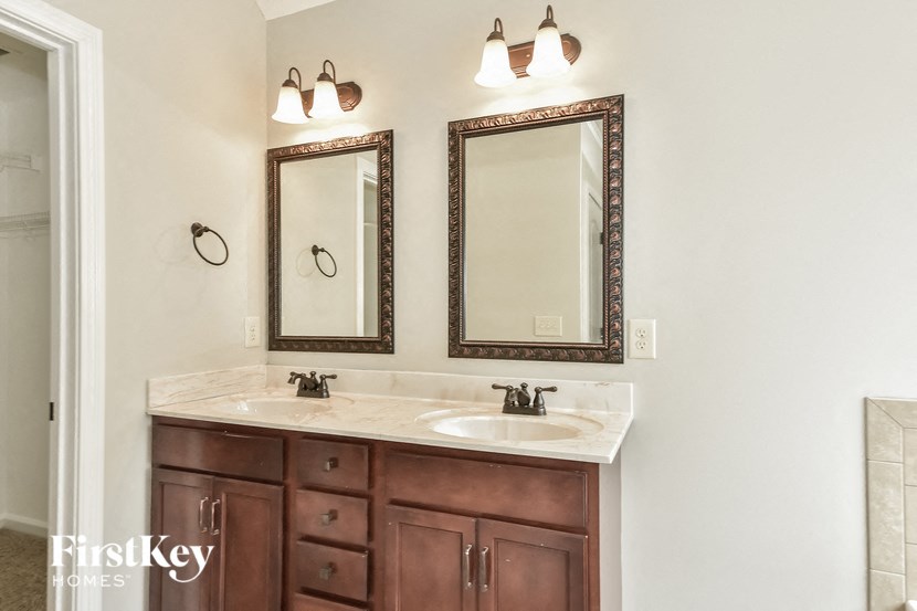 a bathroom with two sinks and two mirrors