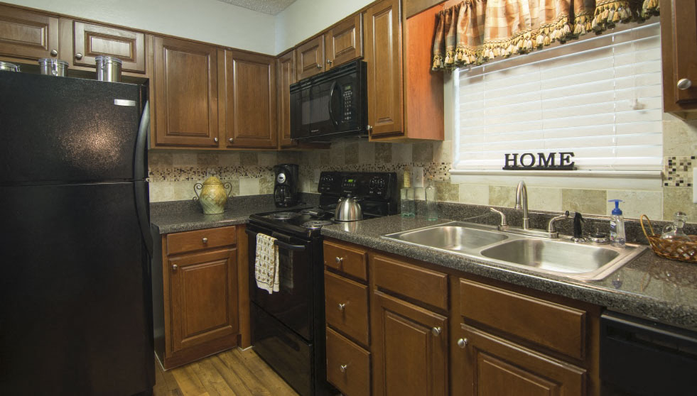a kitchen with a sink and a refrigerator