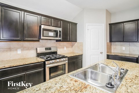 a kitchen with stainless steel appliances and granite counter tops