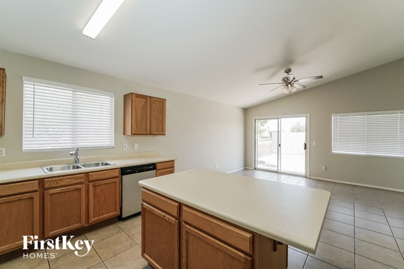a kitchen with wooden cabinets and a white counter top
