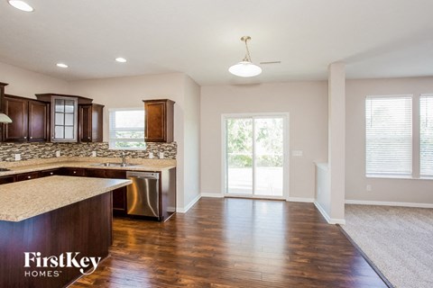 A kitchen with wooden cabinets and a countertop is shown.