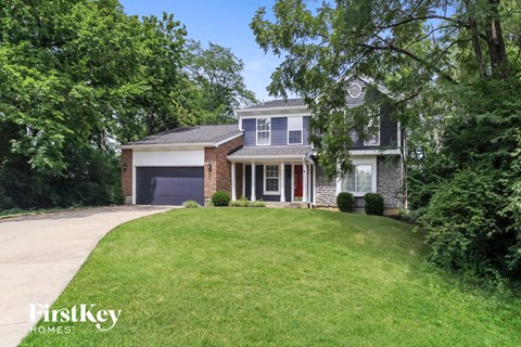 a house with a lawn and a purple garage door