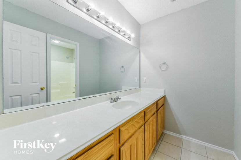 a bathroom with a large mirror and a sink