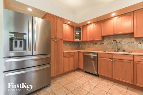 a kitchen with wooden cabinets and stainless steel appliances