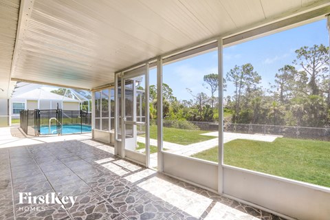 a patio with glass doors and a pool in the backyard
