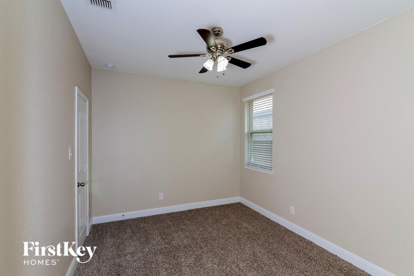 the living room of a home with a ceiling fan