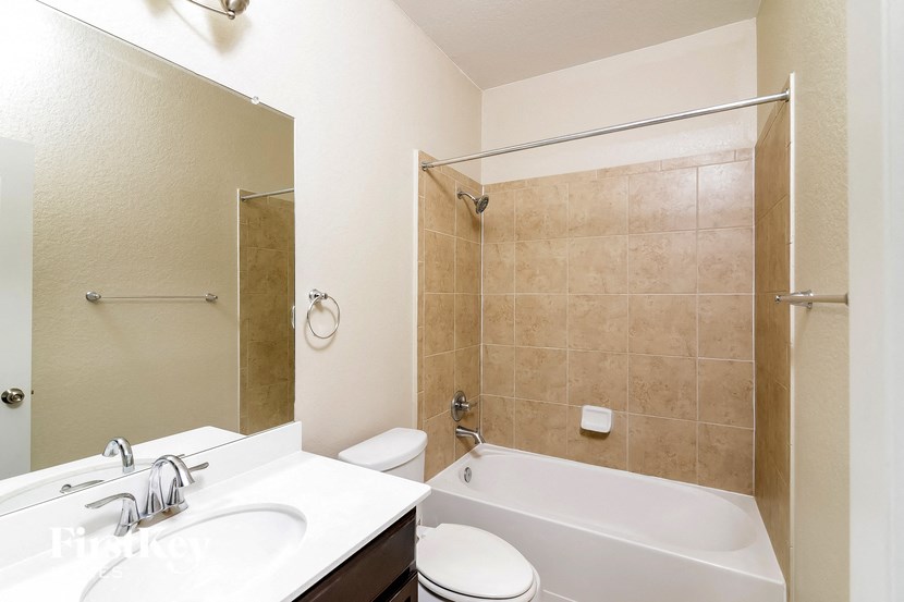 a bathroom with a sink toilet and a bath tub