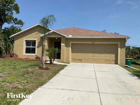 A house with a brown roof and a garage door is for sale.