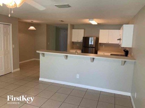 A kitchen with white cabinets and a countertop.