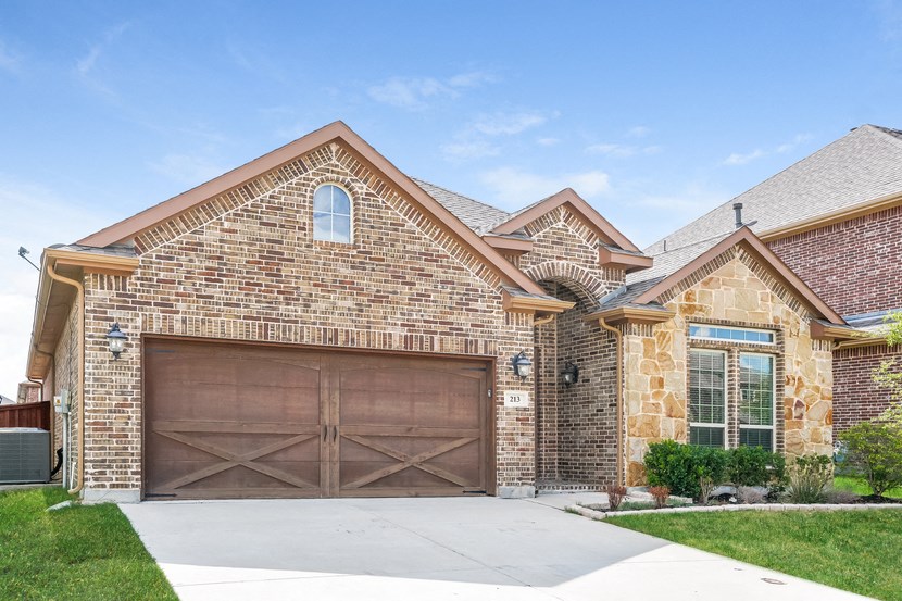a large brick house with a garage door