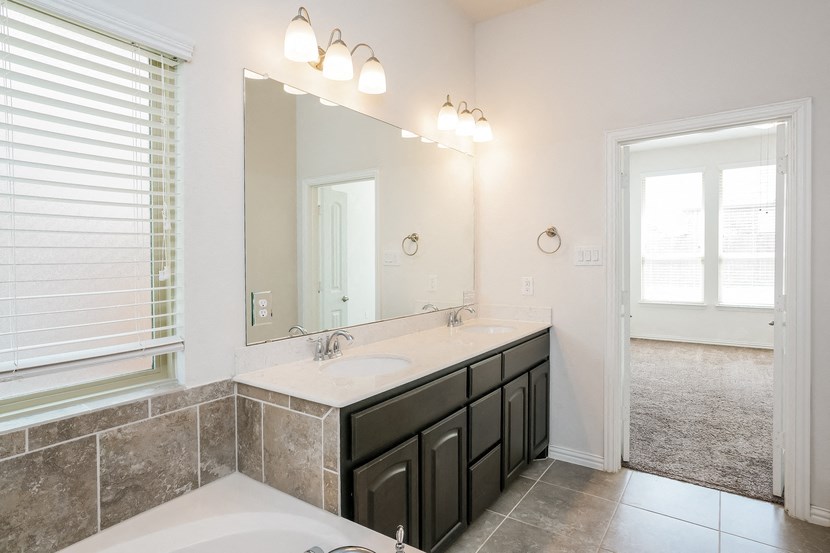 a bathroom with two sinks and a large mirror
