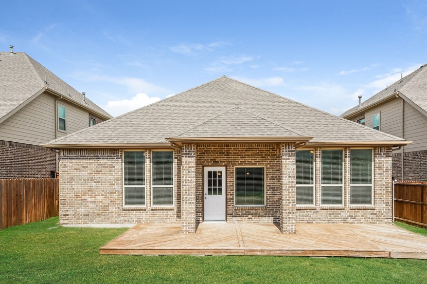 a brick house with a wooden deck in front of it
