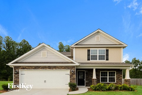 a beige house with a white garage door