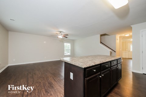 the kitchen is open to the living room and dining room