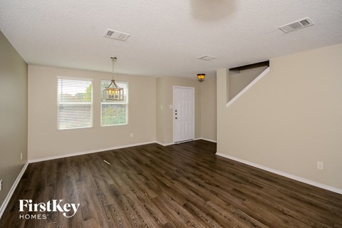 A room with wooden floors and a white door.