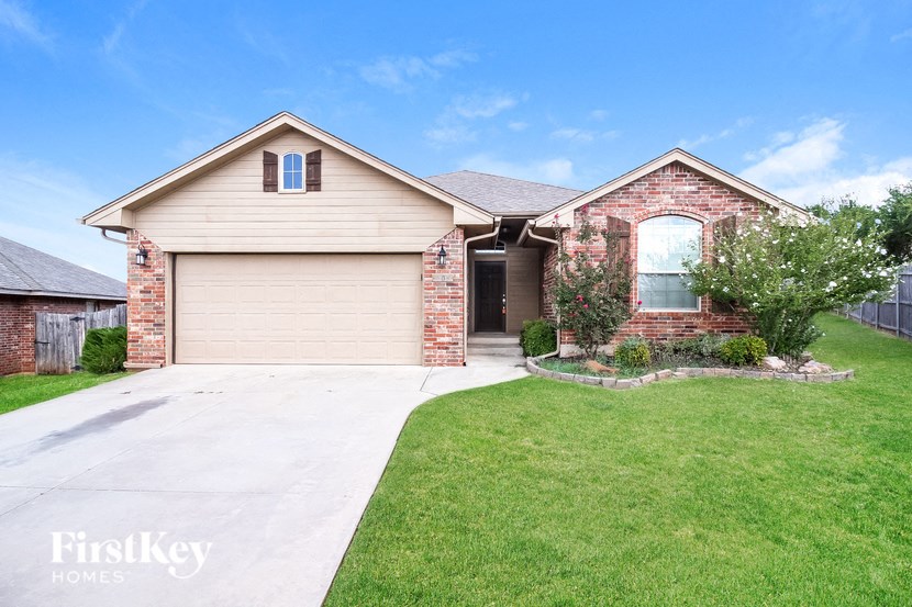a house with a driveway and a lawn