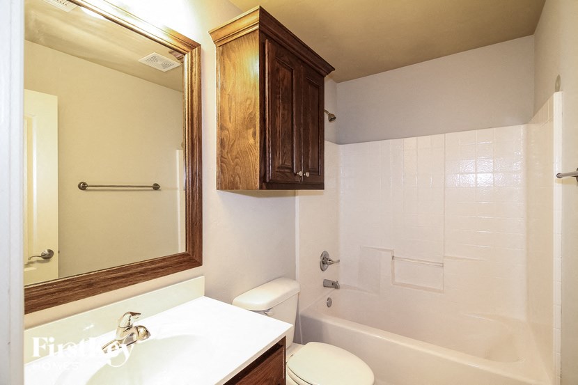 a bathroom with a toilet and a sink and a bath tub