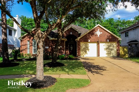 a red brick house with a white garage door