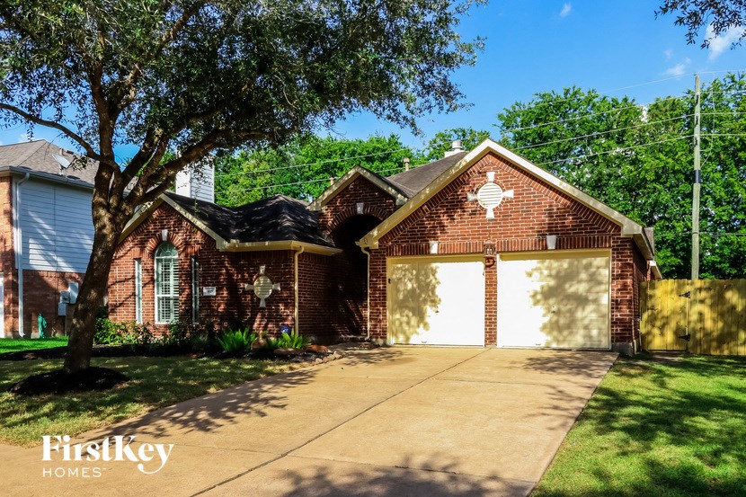a red brick house with a white garage door
