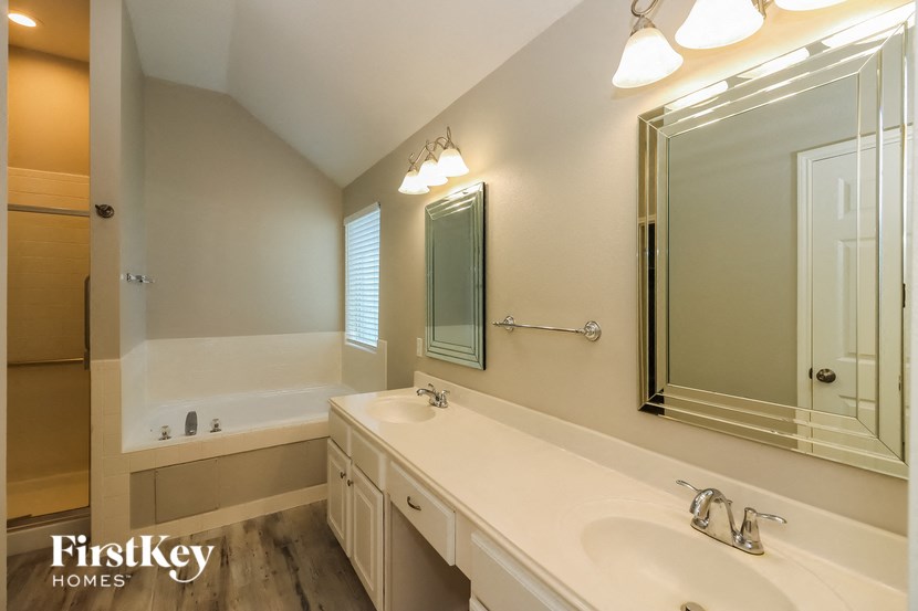 a bathroom with a sink and a tub and a mirror