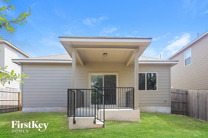 A house with a front porch and a black railing.