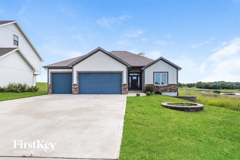 a house with a driveway and a blue garage door