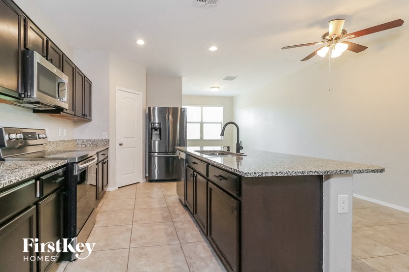 a kitchen with granite counter tops and stainless steel appliances