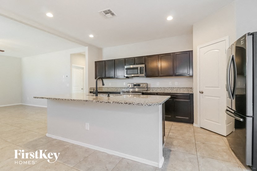a kitchen with a counter top and a refrigerator