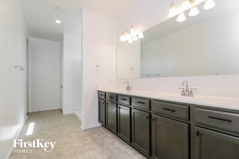 a bathroom with two sinks and a large mirror