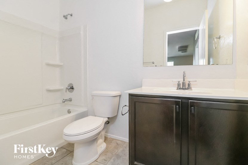 a white bathroom with a toilet and a sink