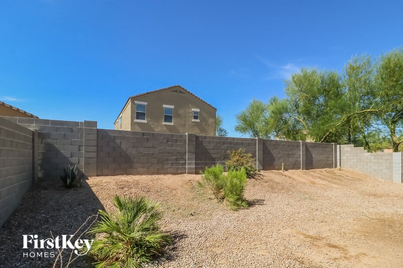a retaining wall with a house in the background