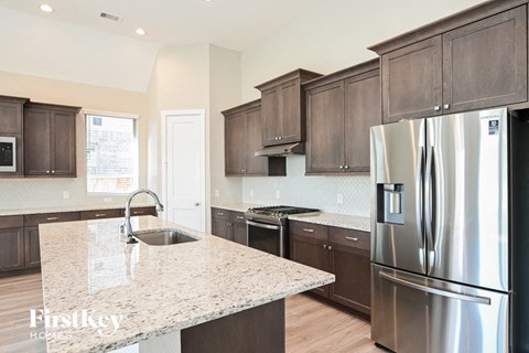 a kitchen with stainless steel appliances and granite counter tops