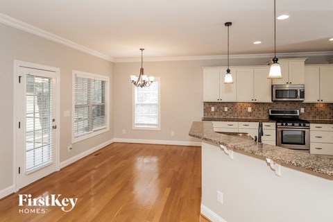 A kitchen with a wooden floor and a counter top.