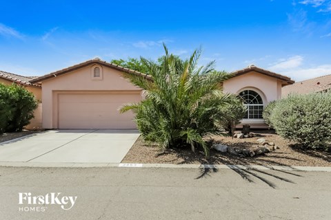 A house with a brown roof and a white garage door is for sale.