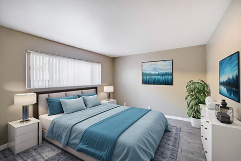 A bedroom with a large bed and a painting on the wall.
