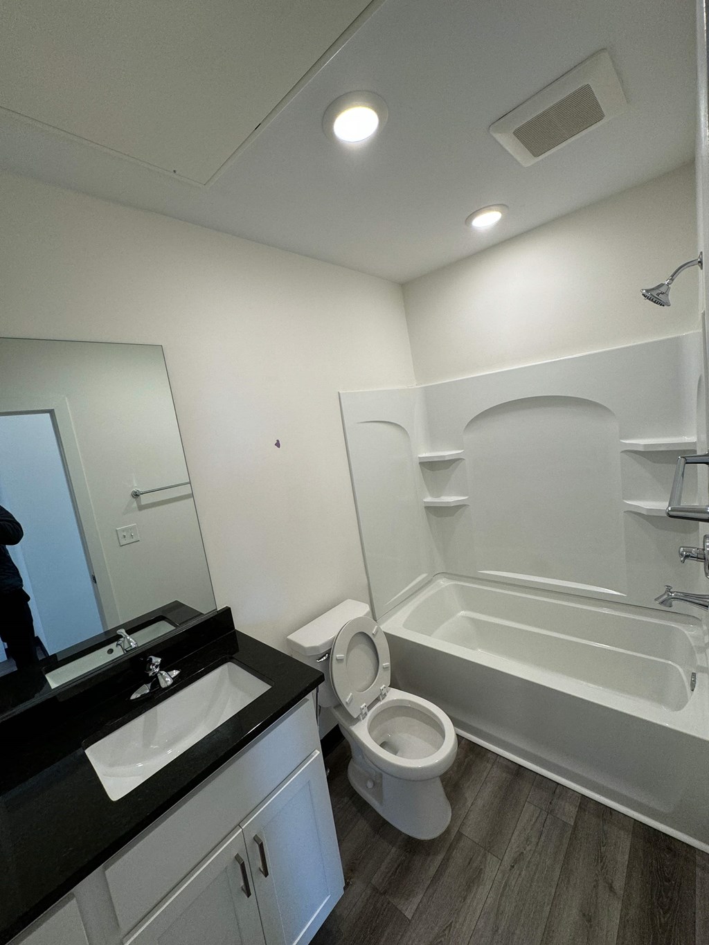 a bathroom with a toilet and a tub and a sink