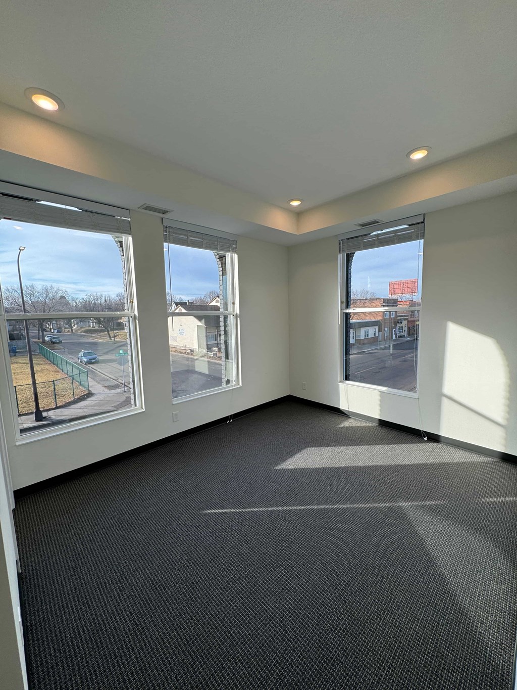 a room with large windows and a carpeted floor