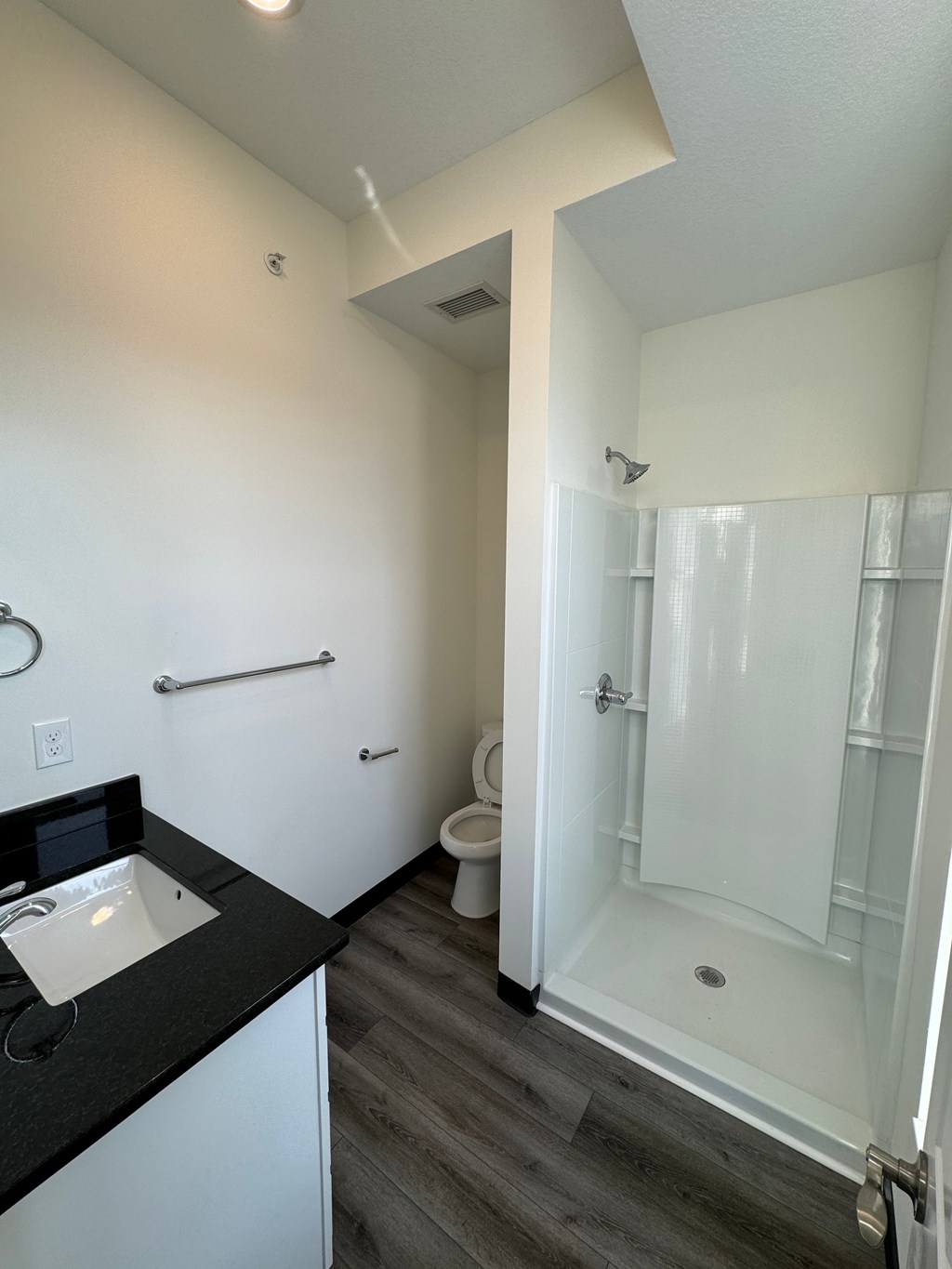 a small bathroom with a shower and a sink