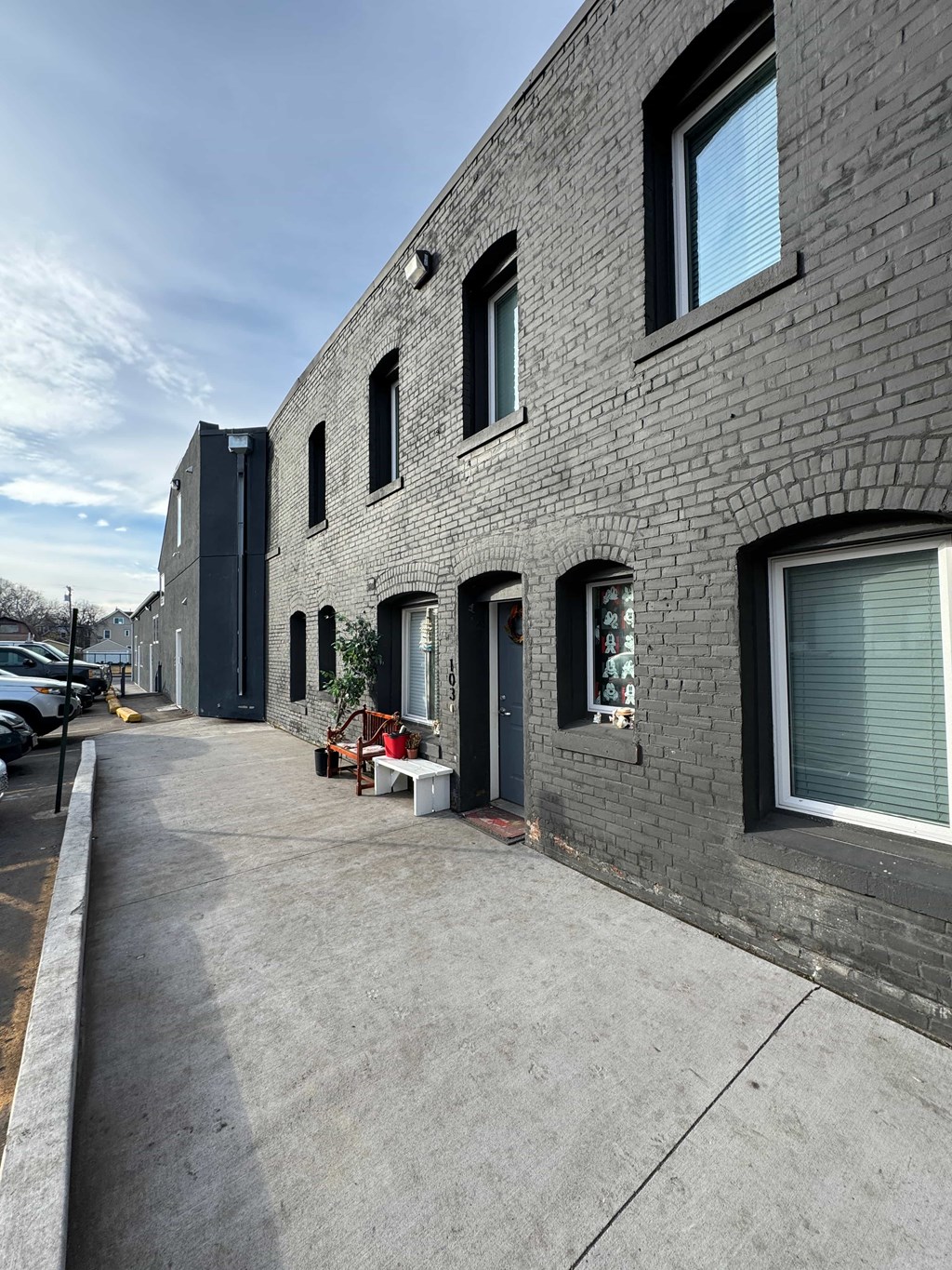 the side of a brick building with a sidewalk