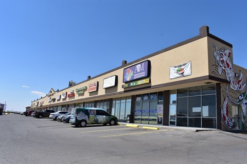 the front of a building with cars parked in front of it