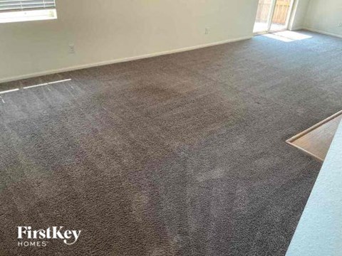 a carpeted floor in a room with a window