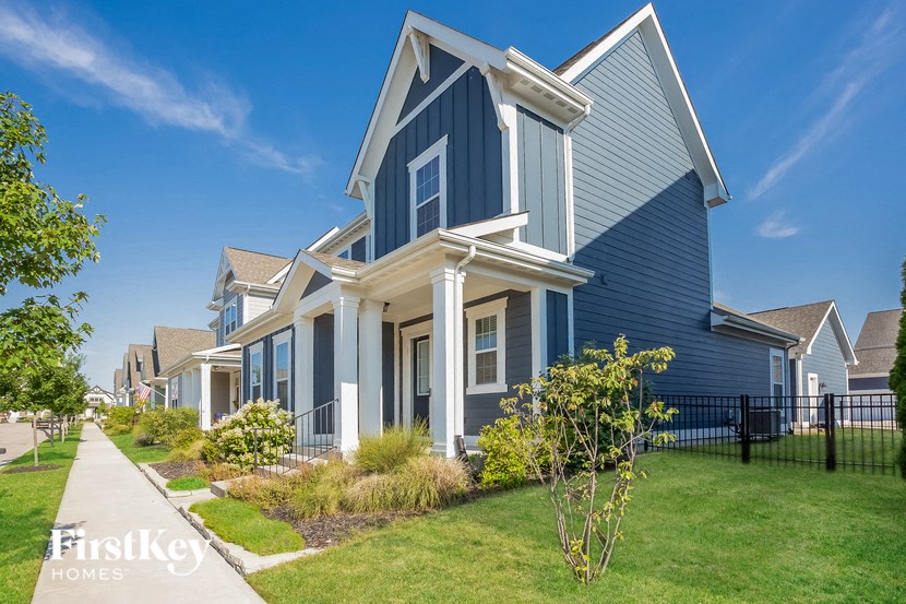 a row of houses with blue siding and a sidewalk