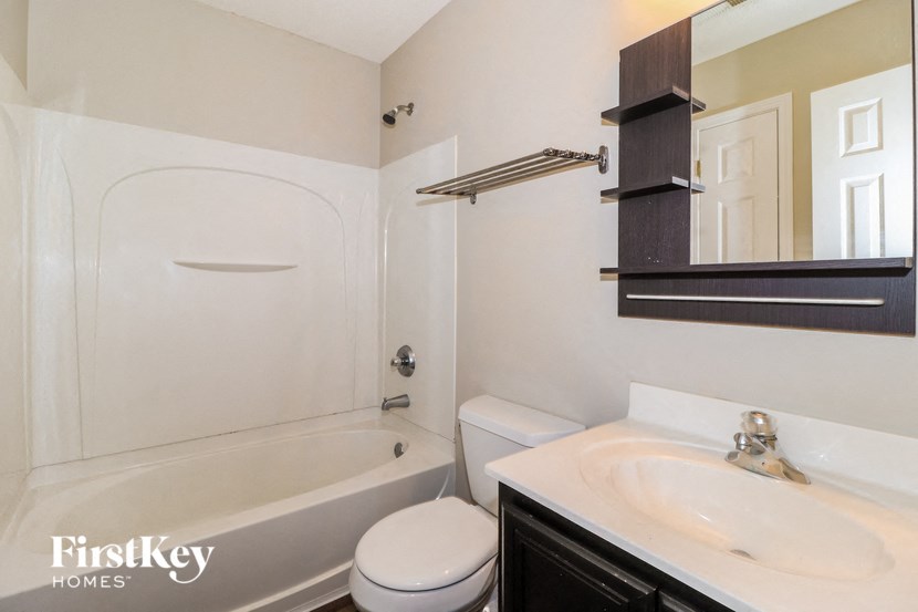 a bathroom with a sink toilet and a bath tub