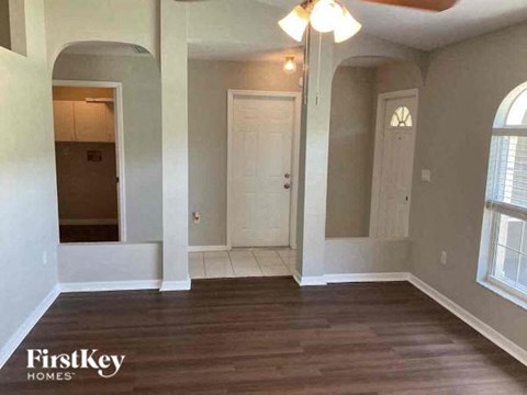 an empty living room with a hard wood floor