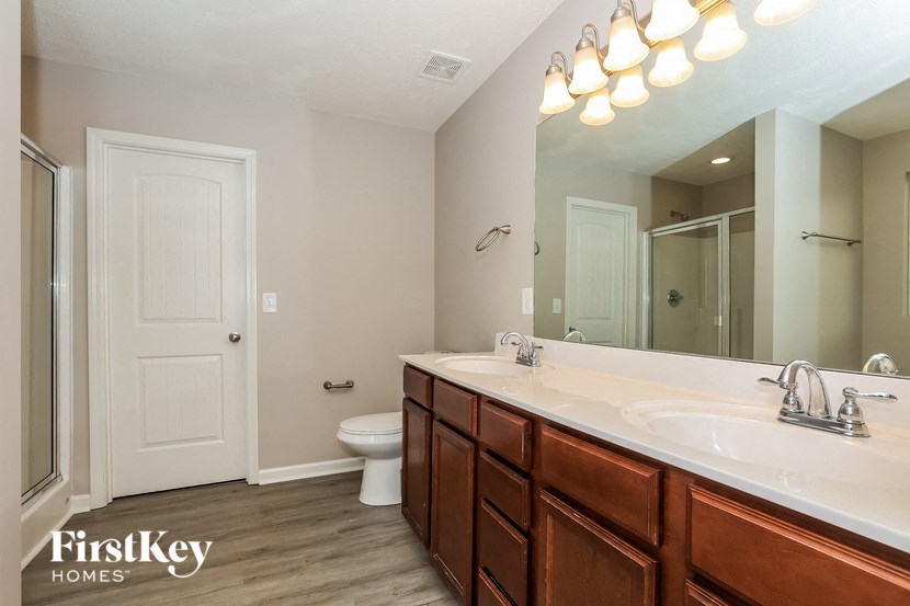 a bathroom with a sink and a toilet and a mirror