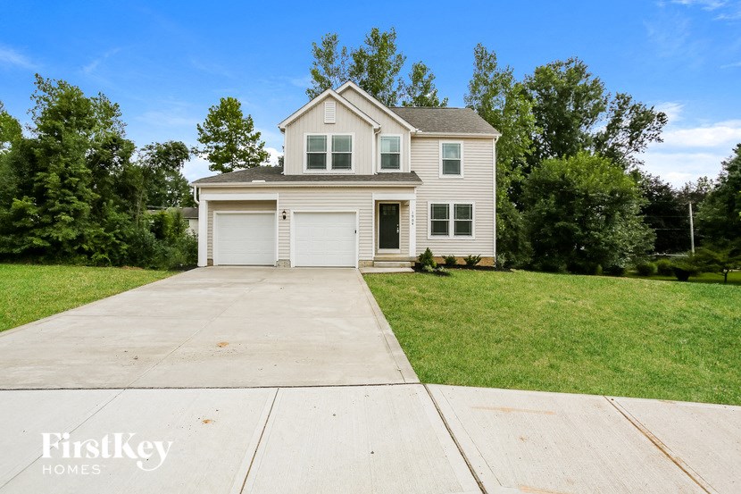 A two-story house with a garage is for sale.