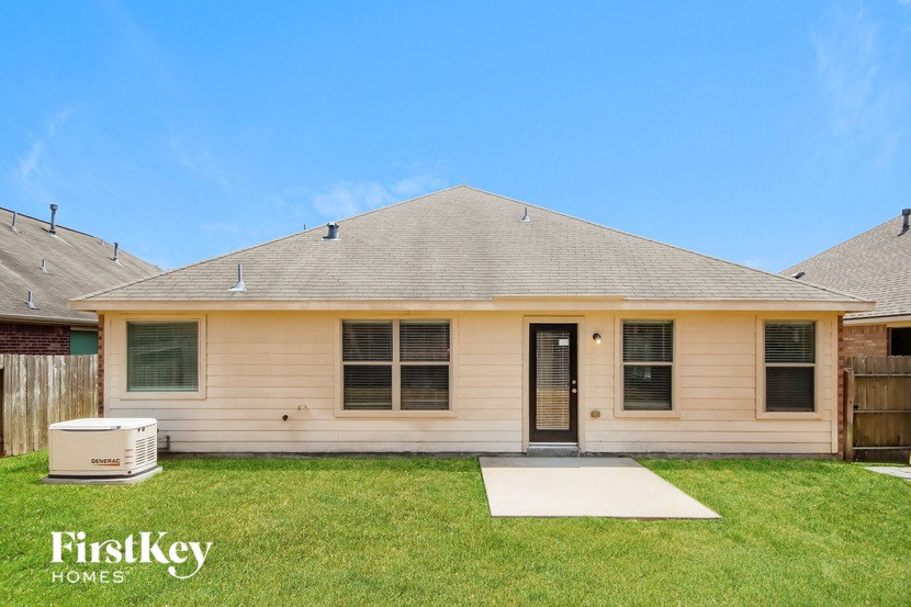 the front of a house with a yard and grass