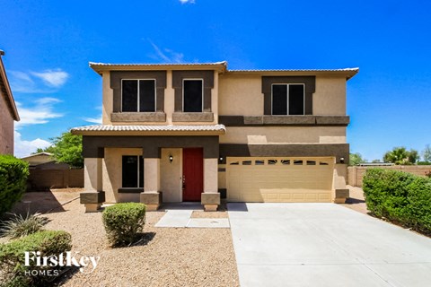 a house with a driveway and a garage door in front of it