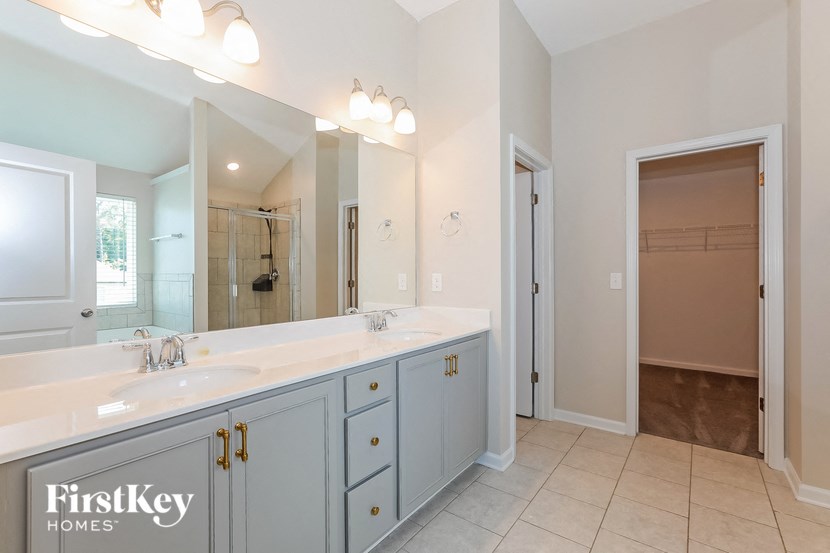 a bathroom with two sinks and a large mirror